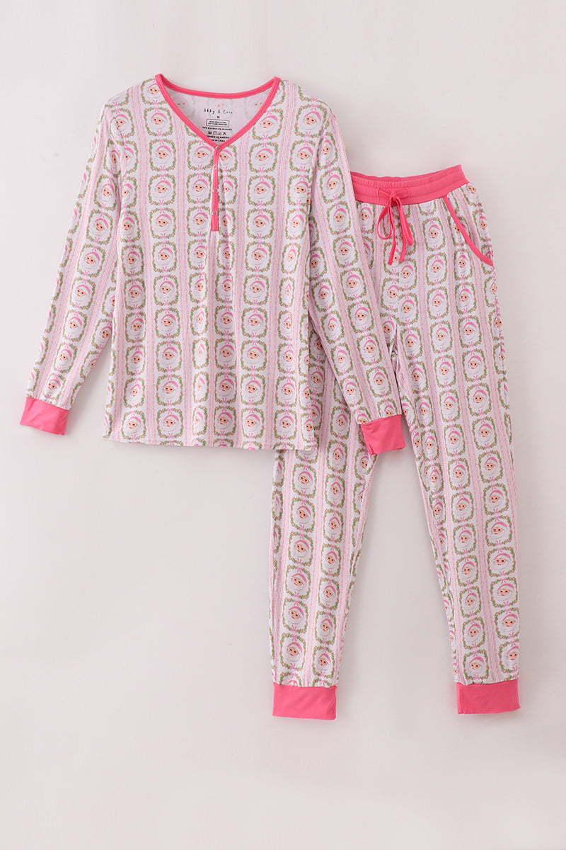 Children's pajama set with pink and white pattern on a light gray background