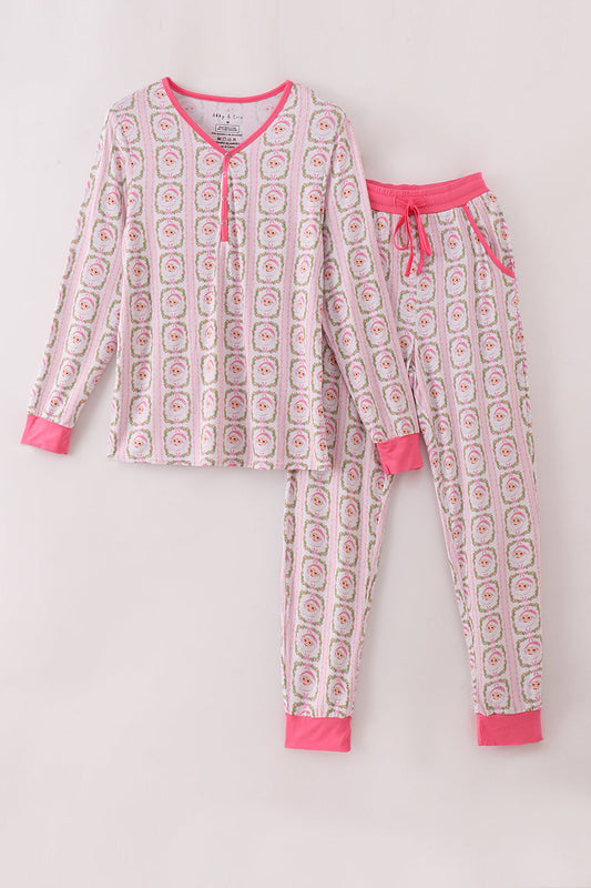 Children's pajama set with pink and white pattern on a light gray background