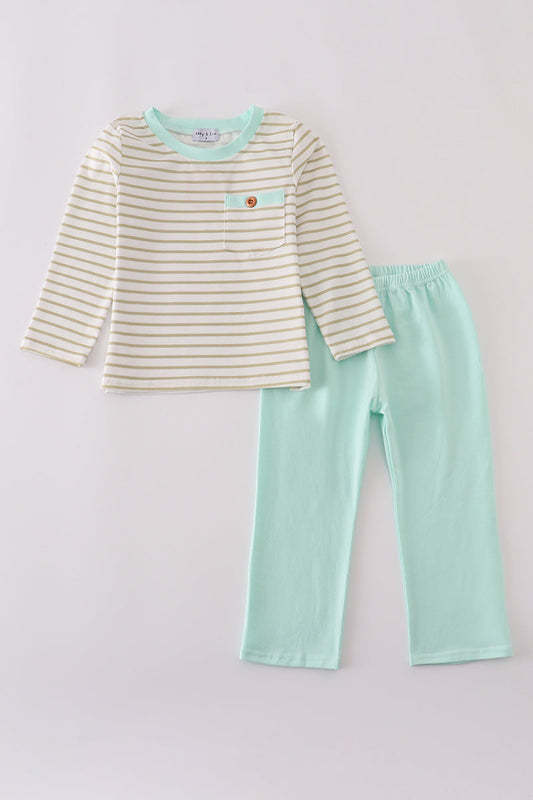 Children's outfit with striped shirt and mint green pants on a light gray background