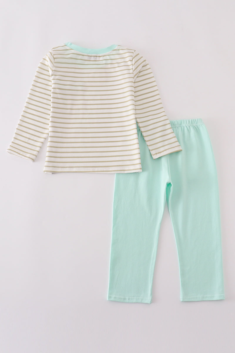 Striped long-sleeve top and mint green pants on a light gray background