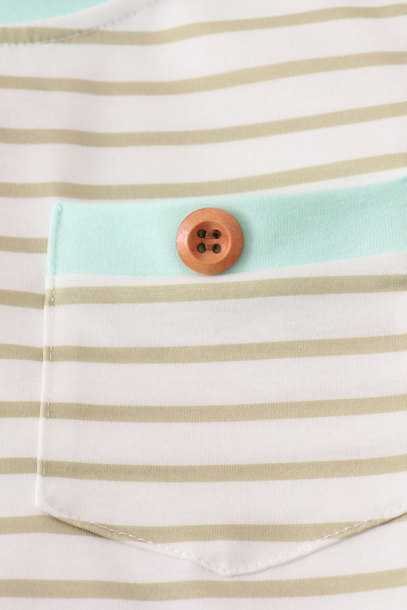 Close-up of a striped shirt with a button on a pocket