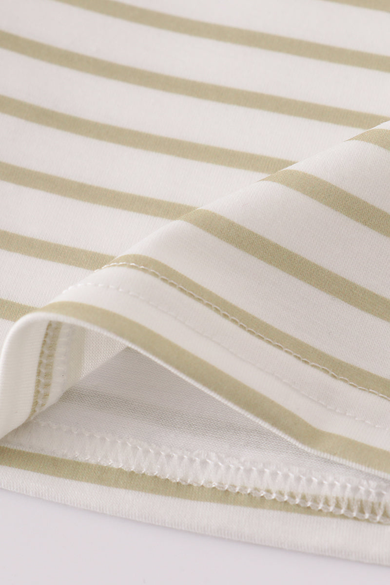 Close-up of striped fabric with beige and white stripes on a light background