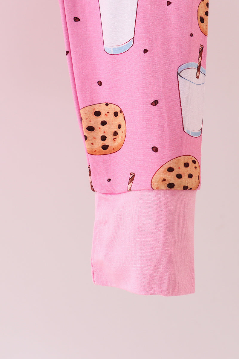 Pink pajama pants with cookie and milk print on a light pink background