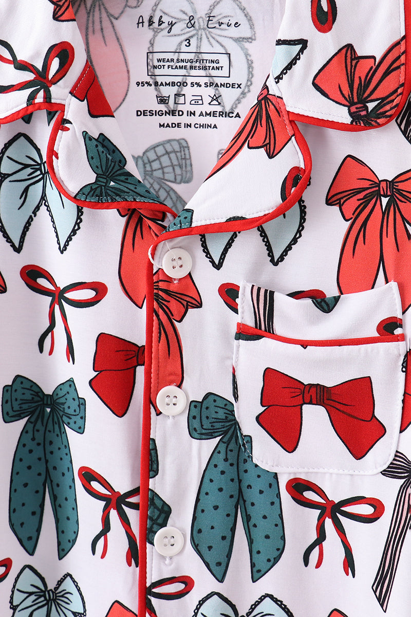 White shirt with colorful bow pattern on a white background
