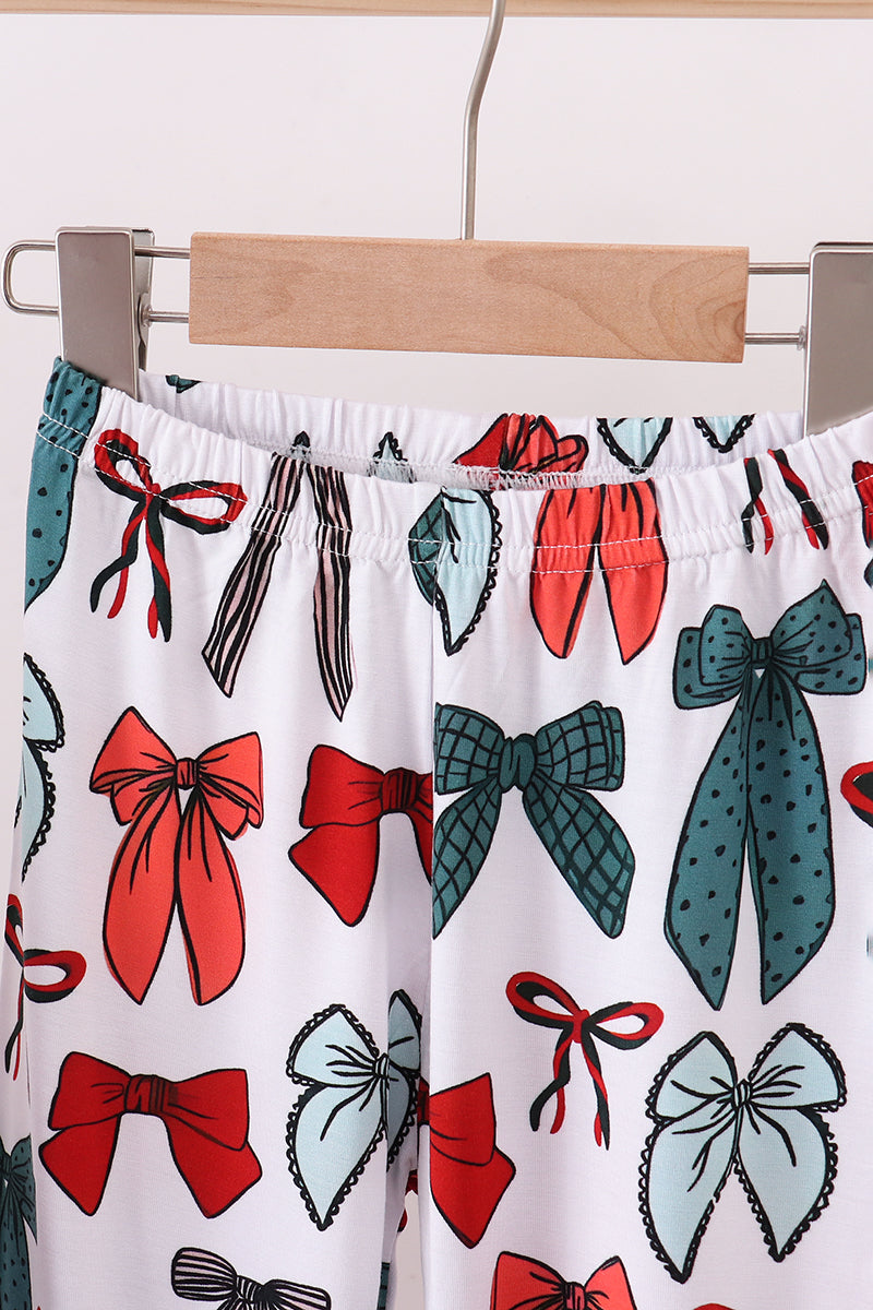 Pajama pants with bow pattern on a hanger