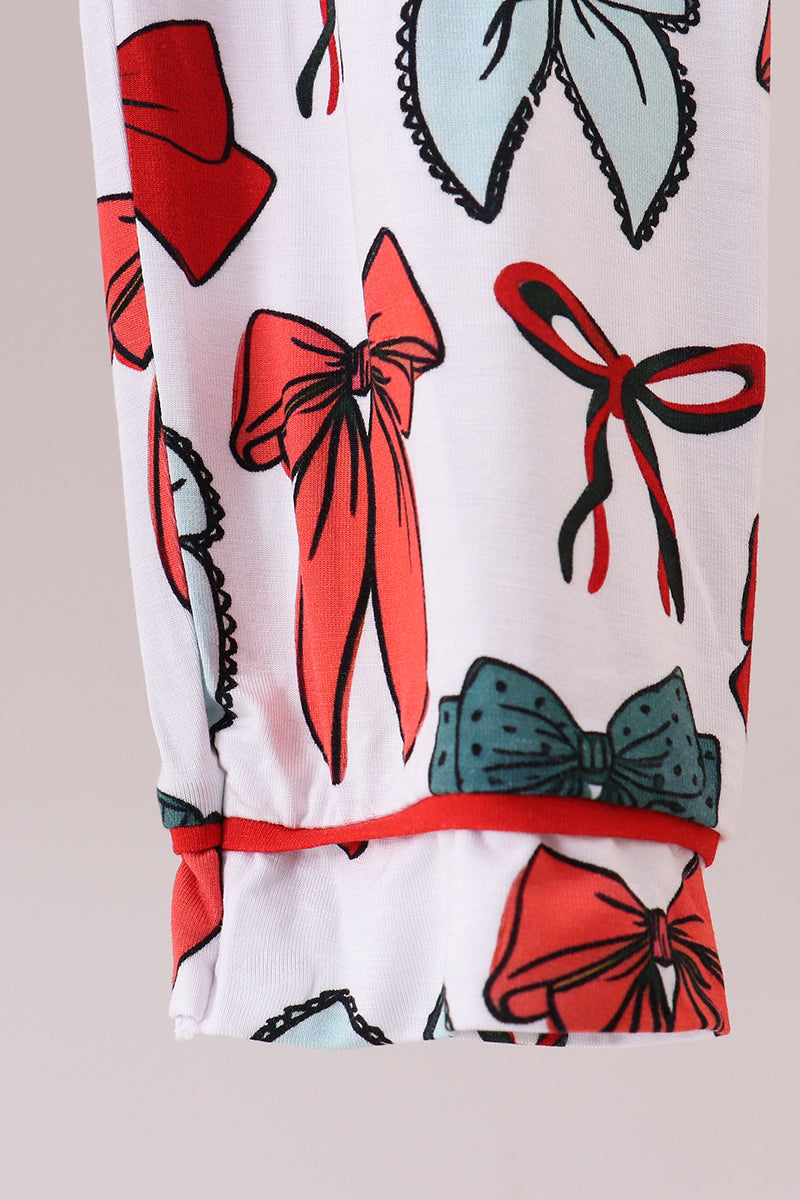 Close-up of a fabric with colorful bow pattern on a white background