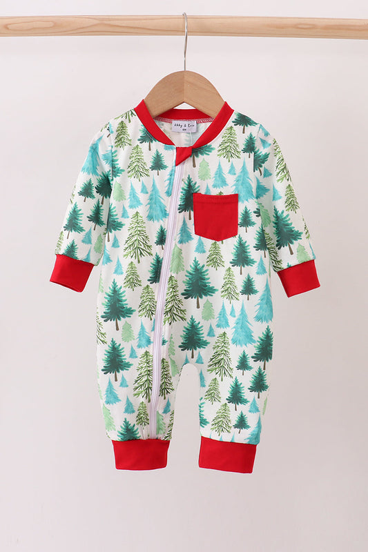 Baby onesie with forest pattern and red accents on a hanger against a light background