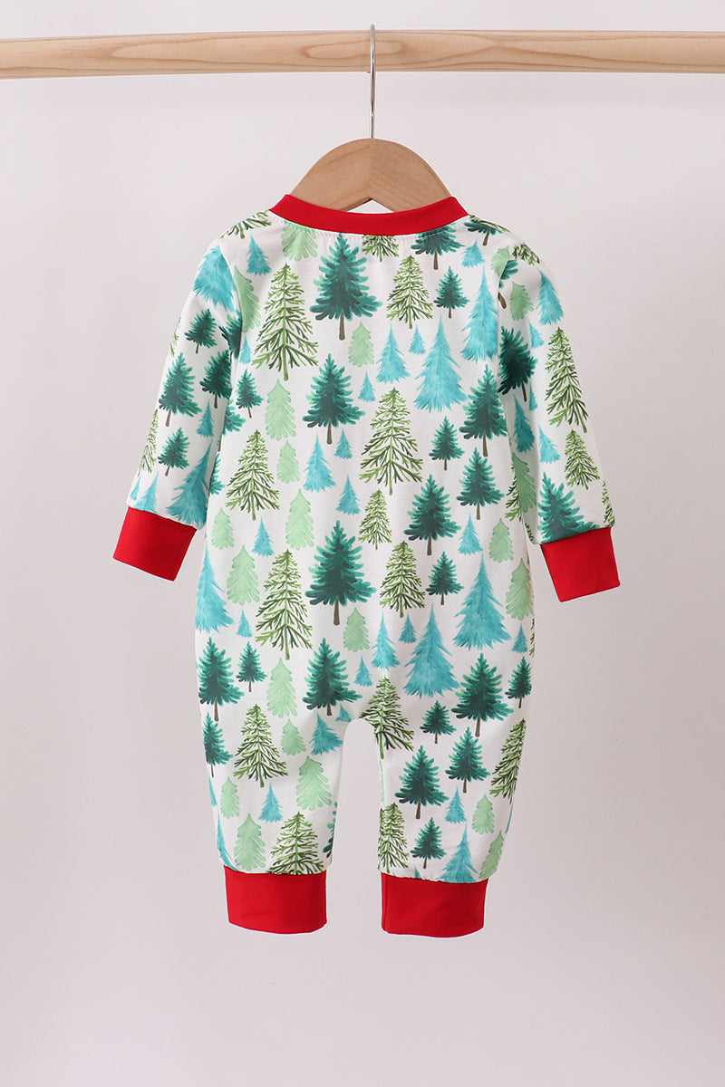 Children's onesie with forest pattern and red cuffs on a hanger against a white background