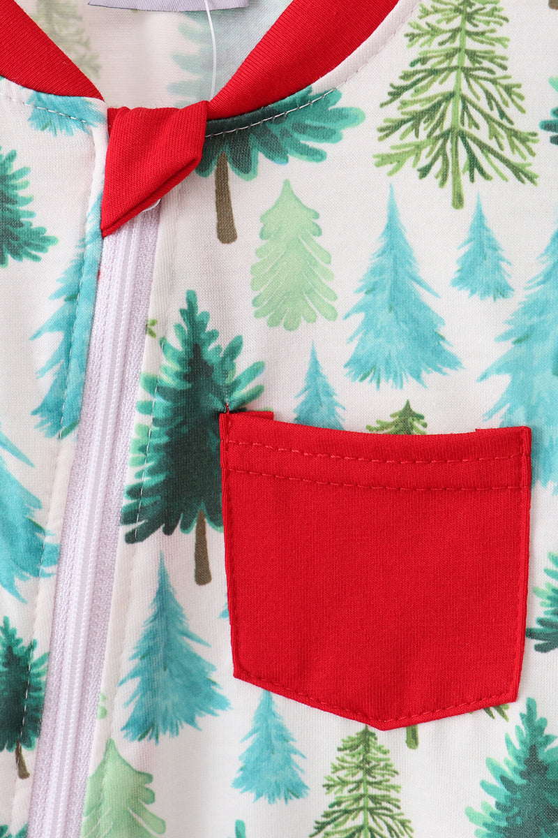 Close-up of a children's outfit with a red pocket and green tree pattern