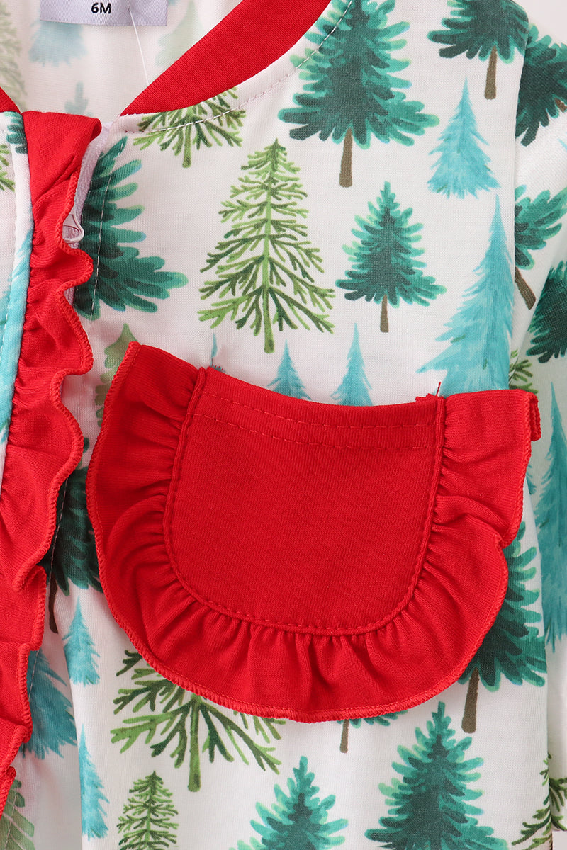 Close-up of a red ruffled pocket on a garment with green tree pattern