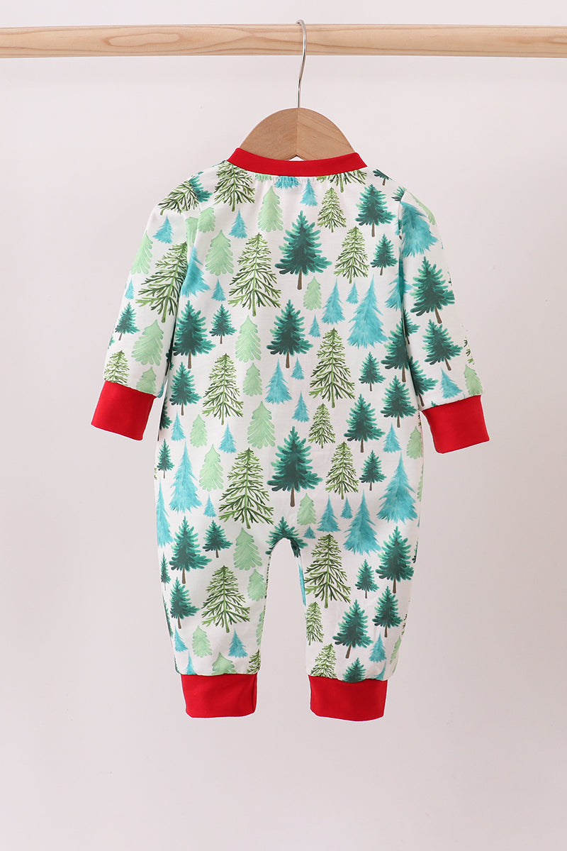 Baby onesie with forest pattern and red cuffs on a hanger against a white background