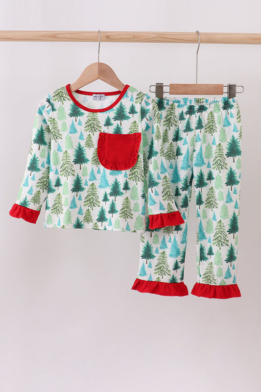 Children's pajama set with tree pattern and red accents on a hanger against a white background