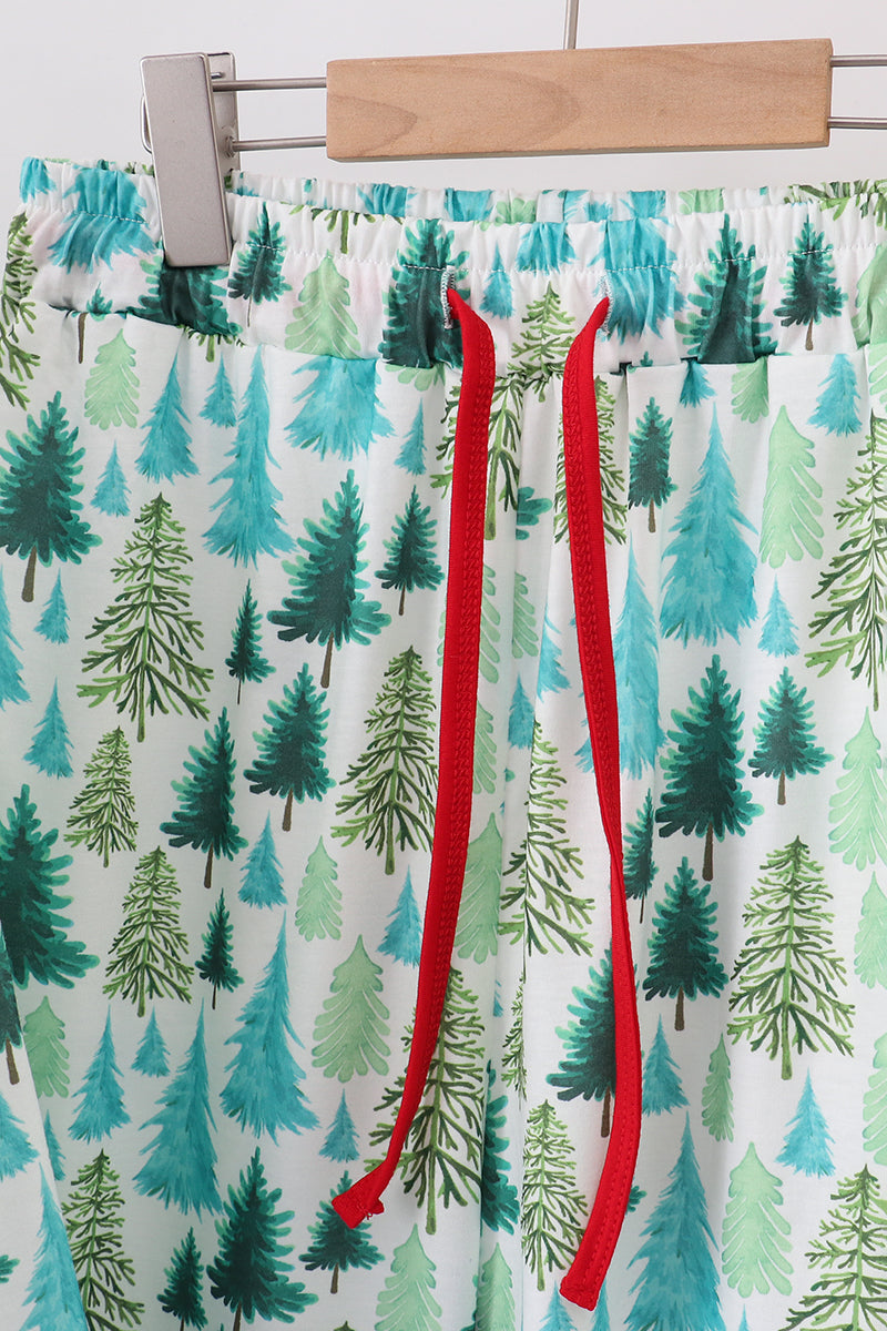 Pajama pants with a forest pattern and red drawstring on a white background