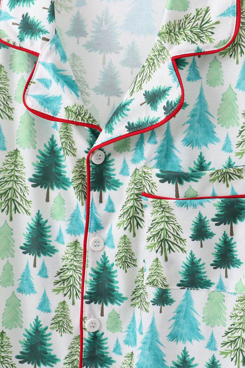 Close-up of a pajama top with a forest pattern and red trim