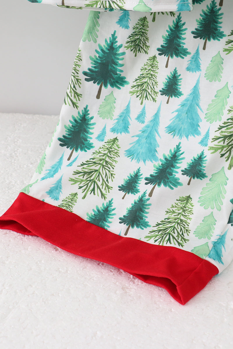 Baby blanket with tree pattern and red border on a white surface