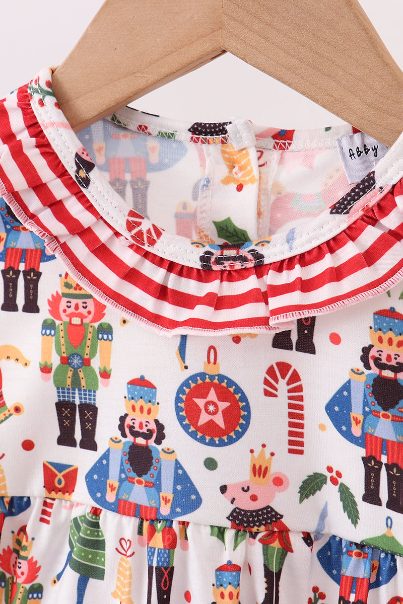 Children's outfit with Nutcracker-themed print on a hanger