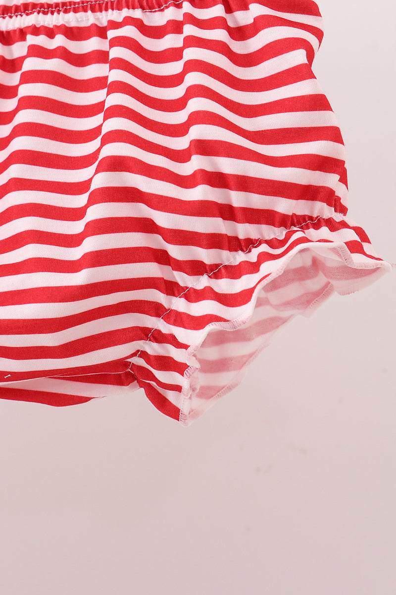Red and white striped fabric on a light pink background