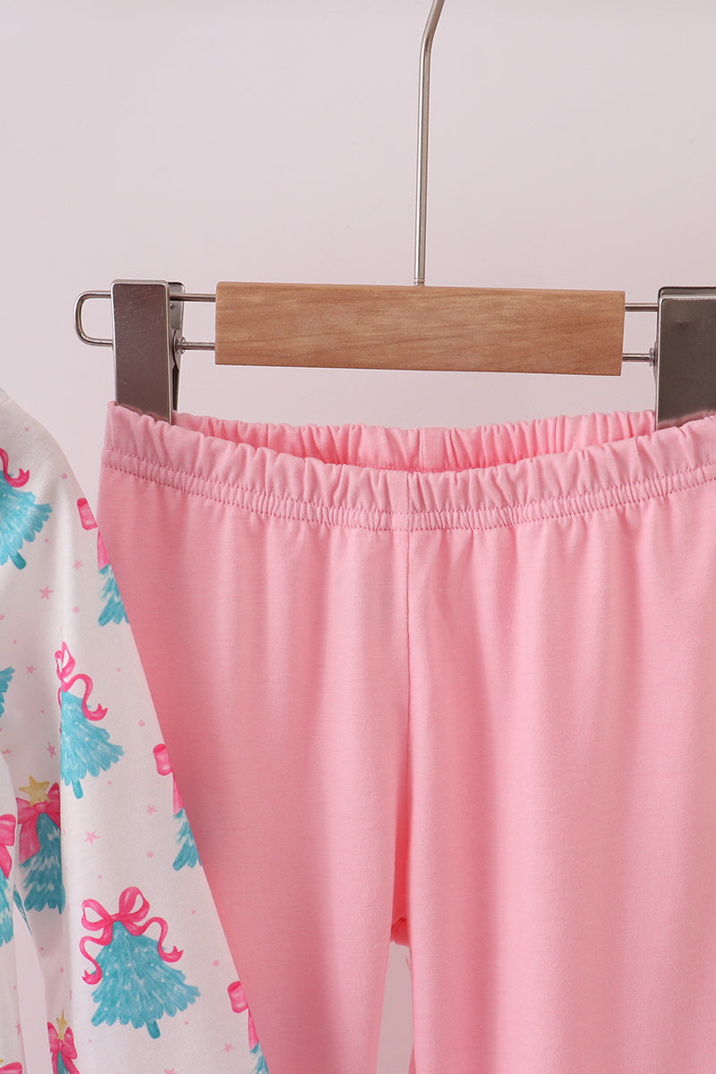 Pink pants on a hanger against a light background