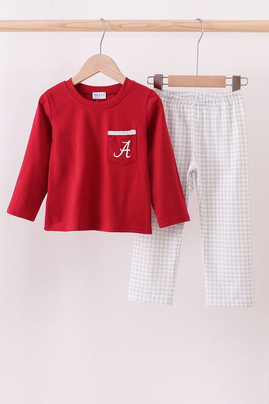 Red long-sleeve shirt with a pocket and white checkered pants on hangers against a light background