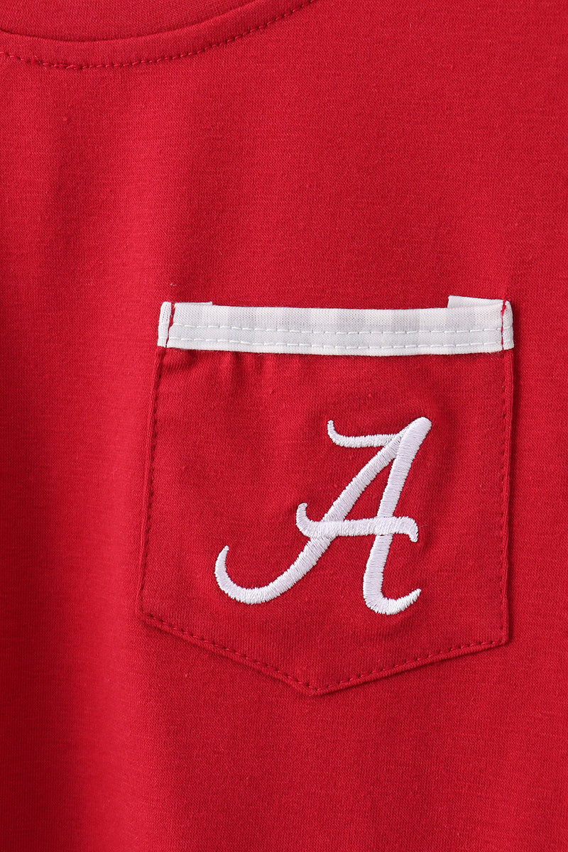 Red shirt with a white pocket and embroidered letter 'A' on a red background