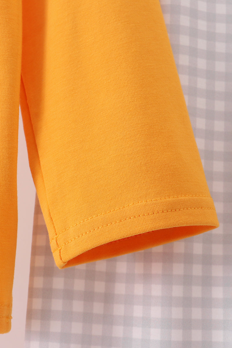 Close-up of a yellow sleeve on a checkered background