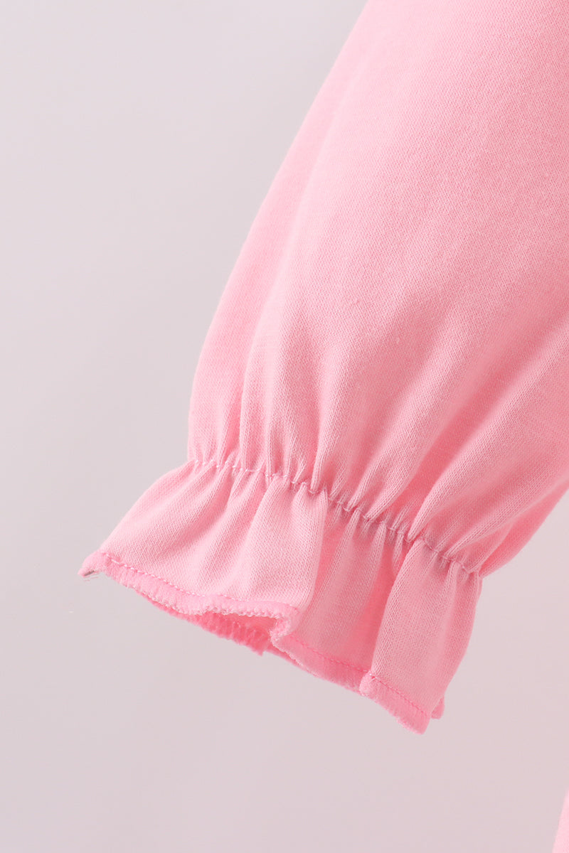 Close-up of a pink fabric edge on a light gray background