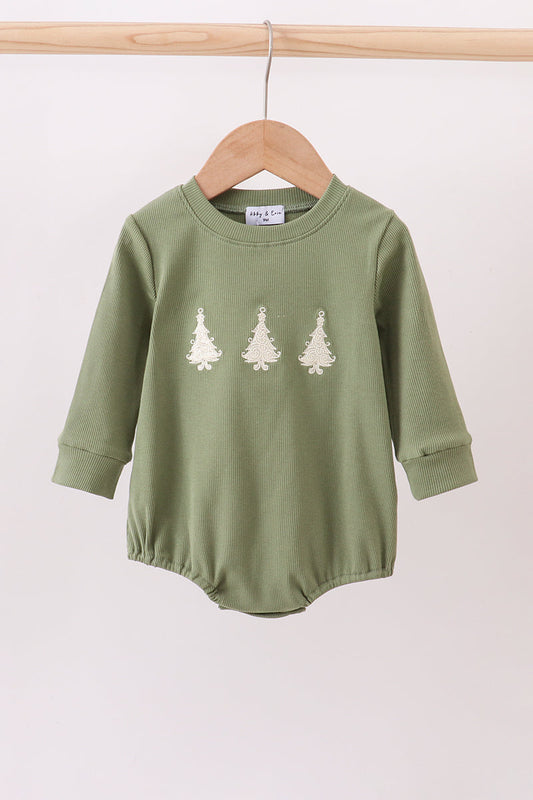 Green baby romper with tree patterns on a wooden hanger against a white background