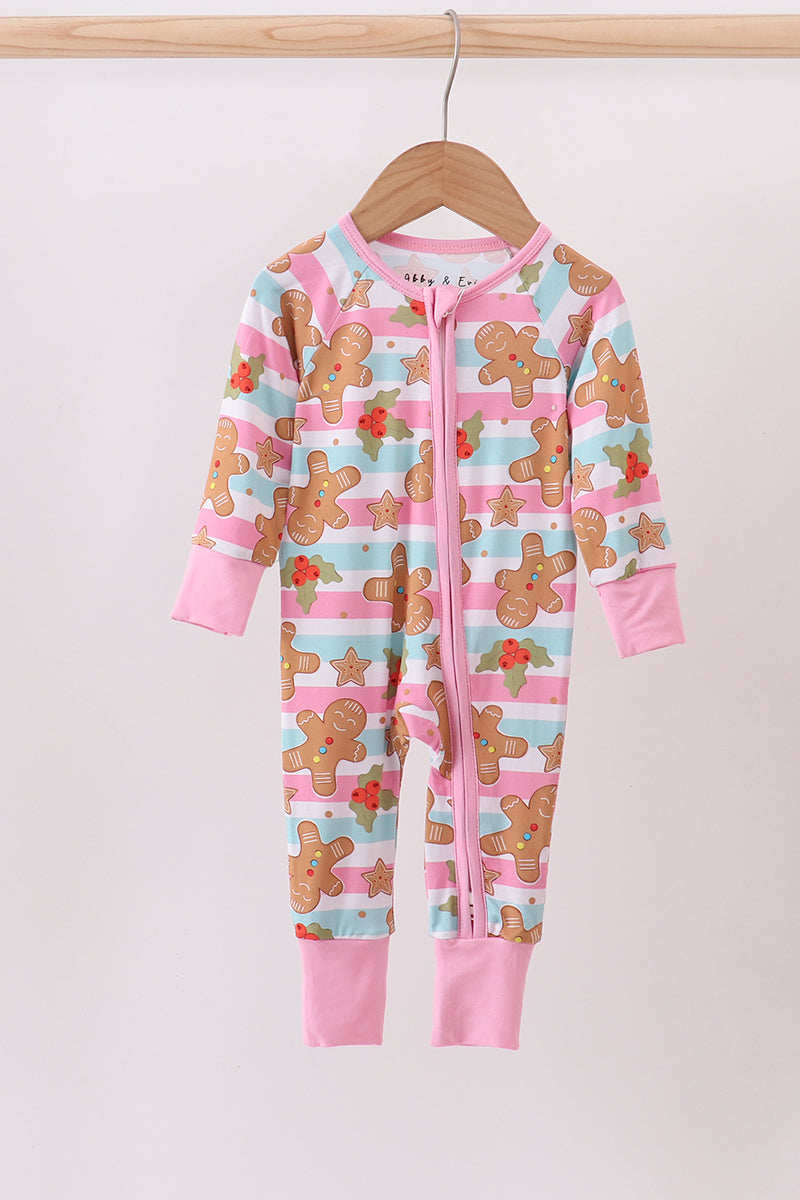 Children's onesie with gingerbread man pattern on a hanger against a white background