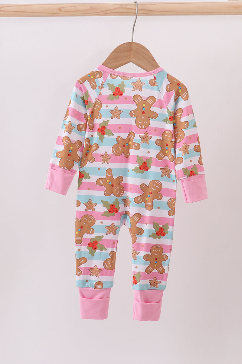 Children's onesie with gingerbread man pattern on a hanger against a white background