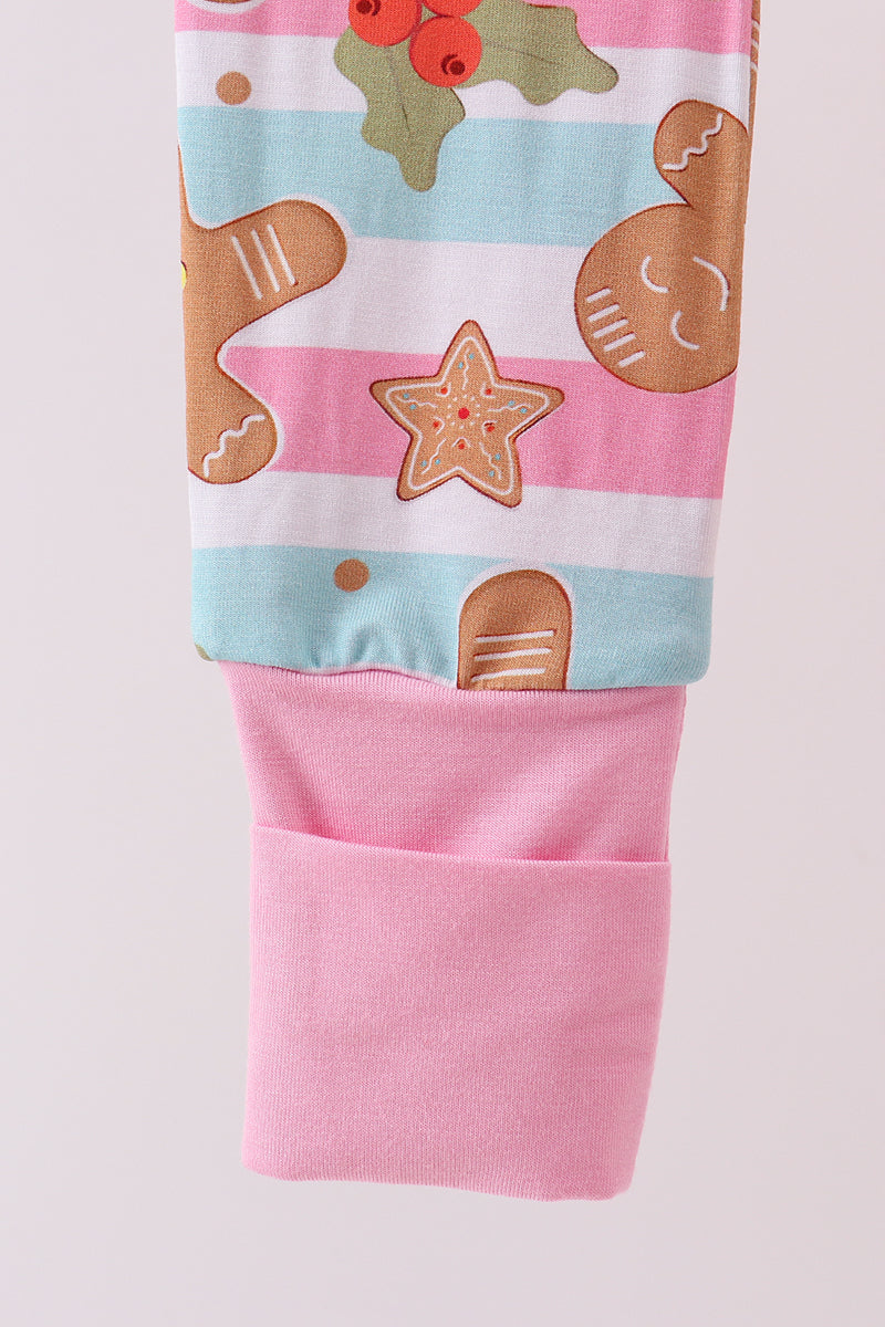 Pink leggings with gingerbread-themed design on a light pink background