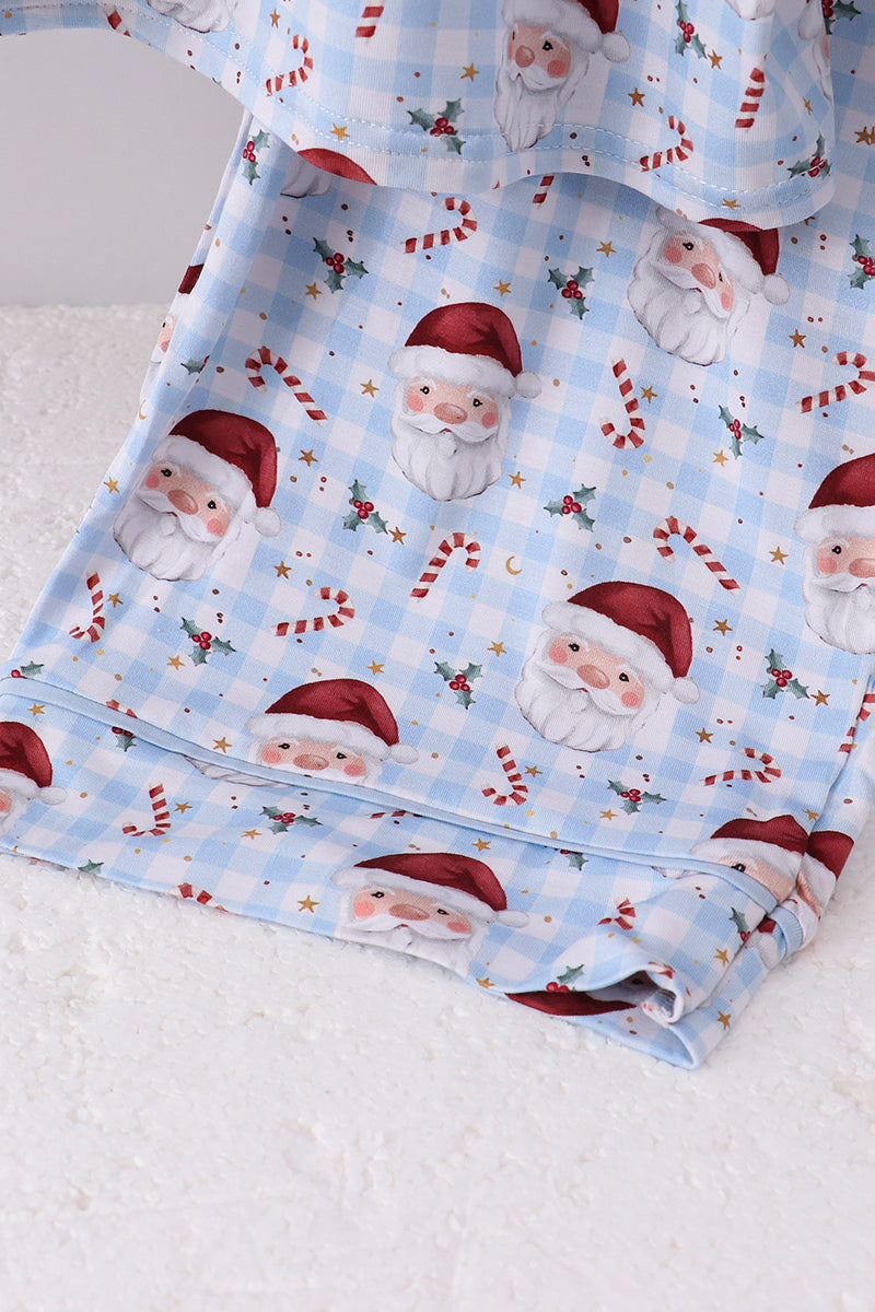 Folded fabric with Santa Claus and candy cane pattern on a light blue background