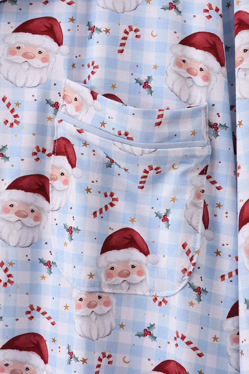Festive fabric with Santa Claus and candy cane pattern on a blue checkered background