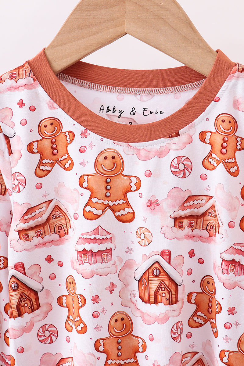 Children's shirt with gingerbread man and house pattern on a hanger