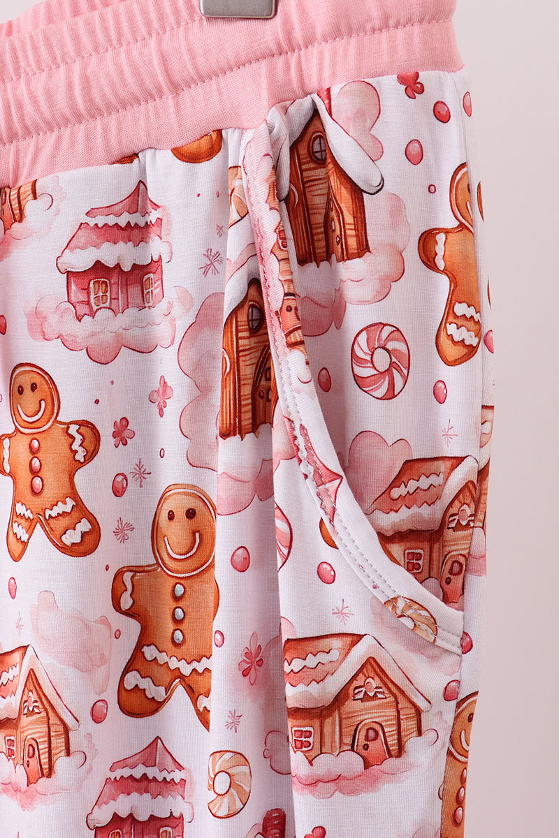 Pants with gingerbread man and house pattern on a white background