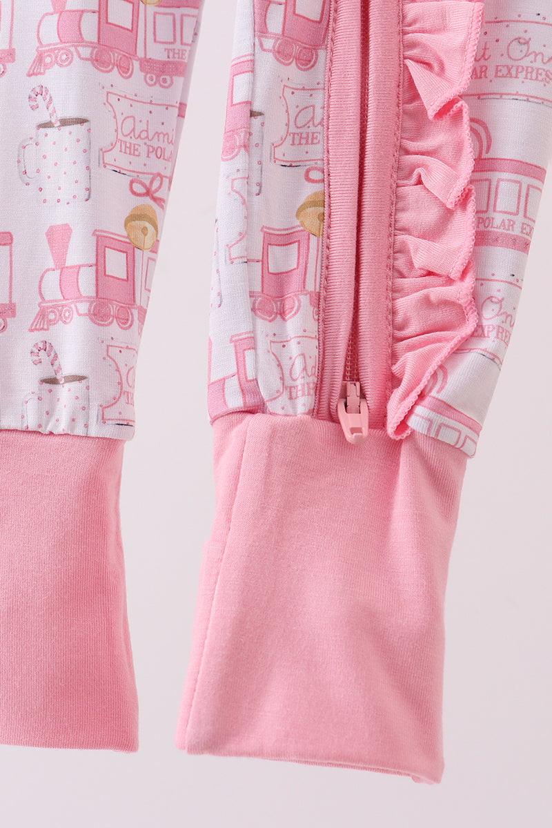 Pink children's outfit with train design on a light pink background