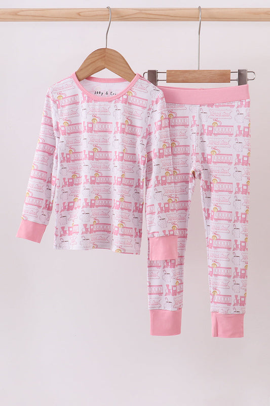 Children's pajama set with pink and white design on a hanger against a white background