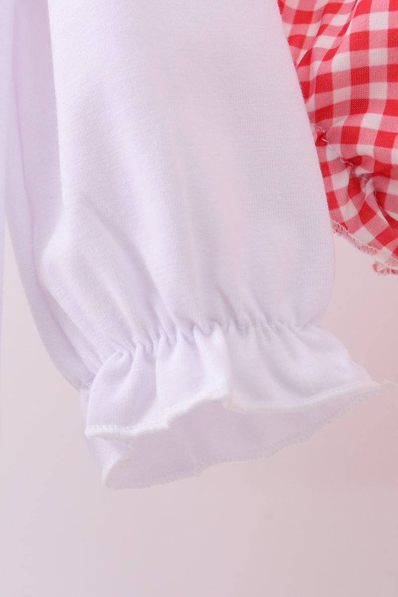 White pet bed with red and white checkered fabric on a light background
