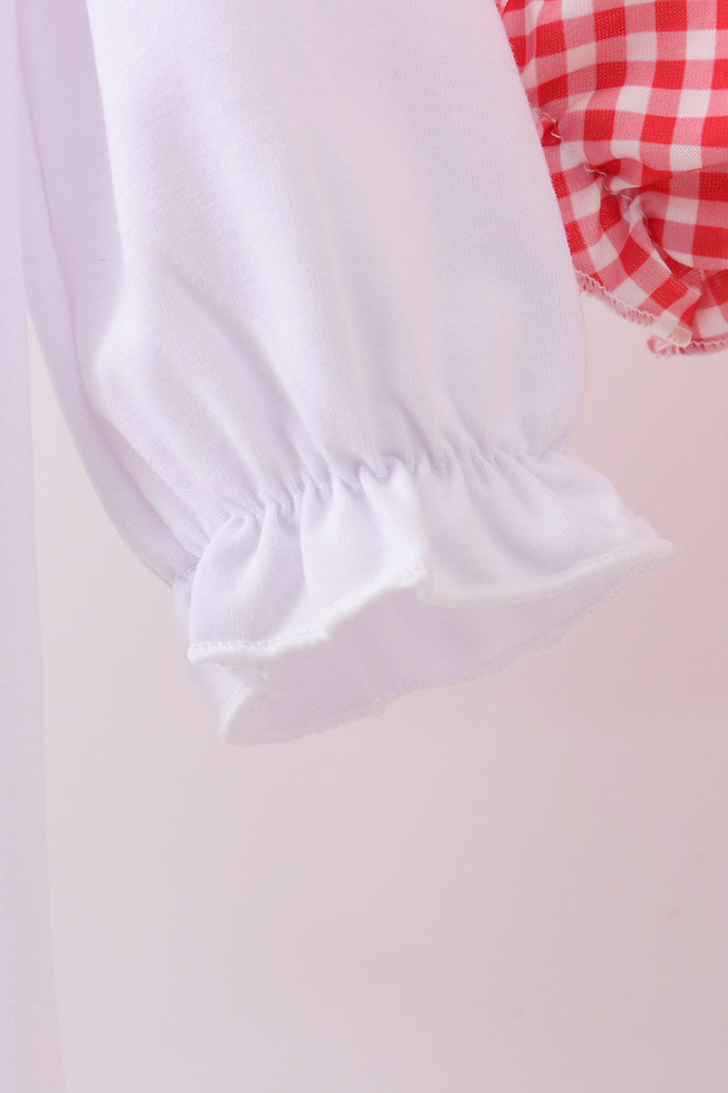 White lace trim on a red and white checkered fabric background