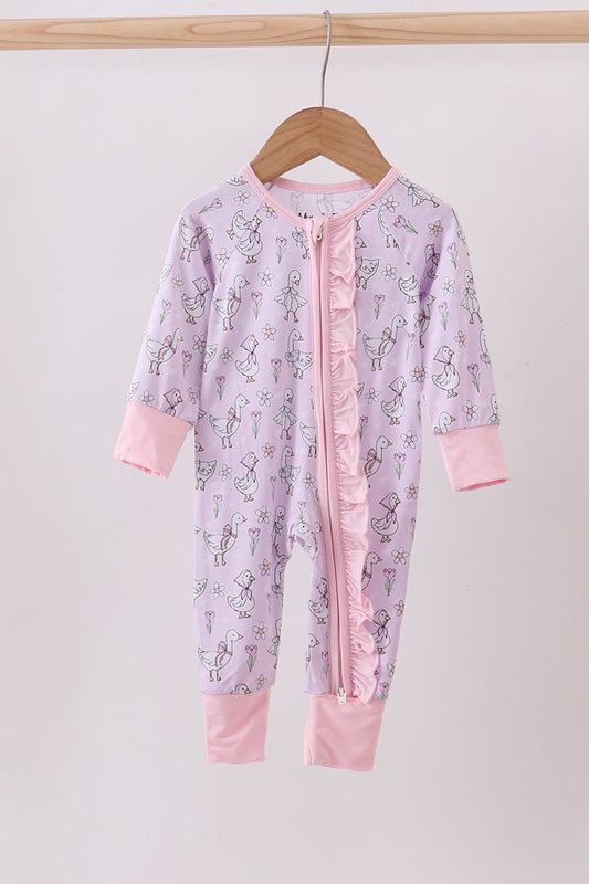 Pink baby onesie with ruffle details on a wooden hanger against a white background