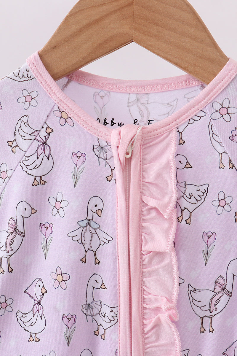 Baby onesie with duck and flower pattern on a hanger