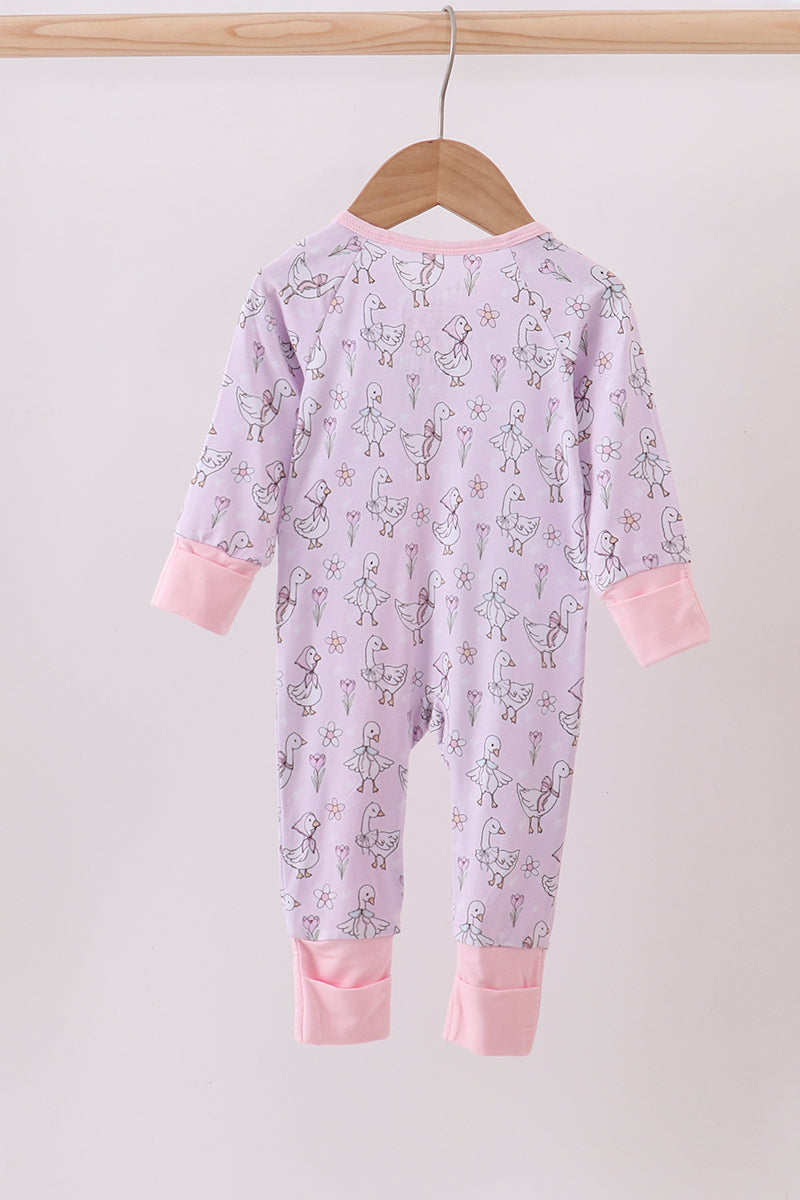 Pink baby onesie with a pattern on a hanger against a white background