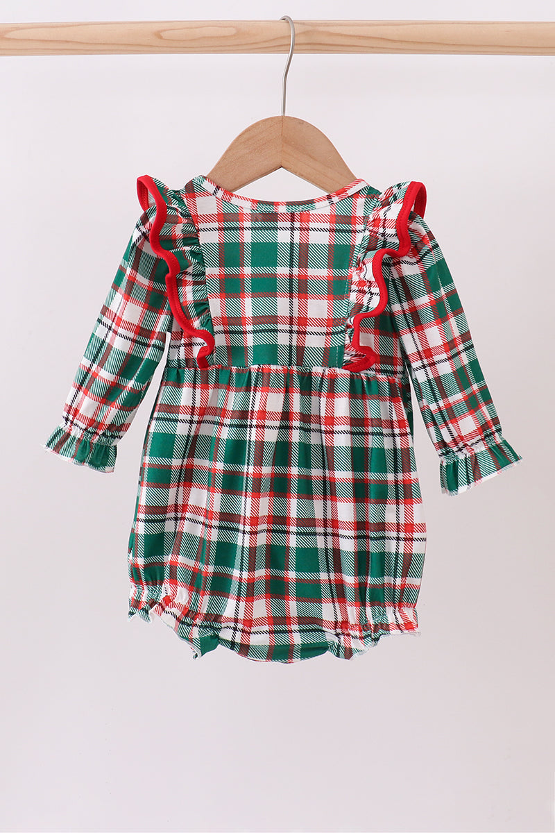 Plaid baby romper with red trim on a wooden hanger against a white background