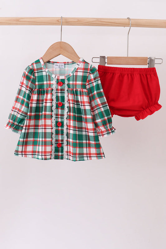 Plaid shirt with lace trim and red shorts on a hanger against a white background