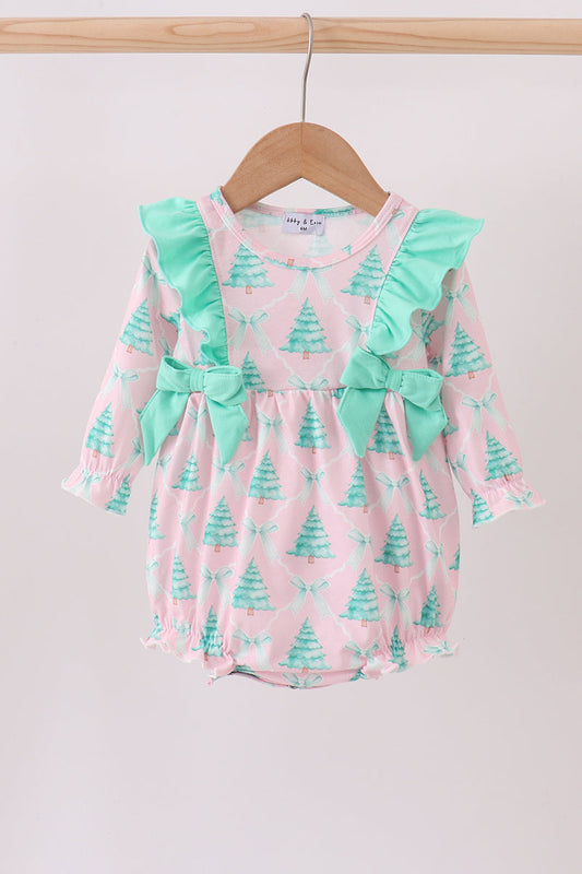 Baby romper with Christmas tree pattern and green ruffles on a wooden hanger.