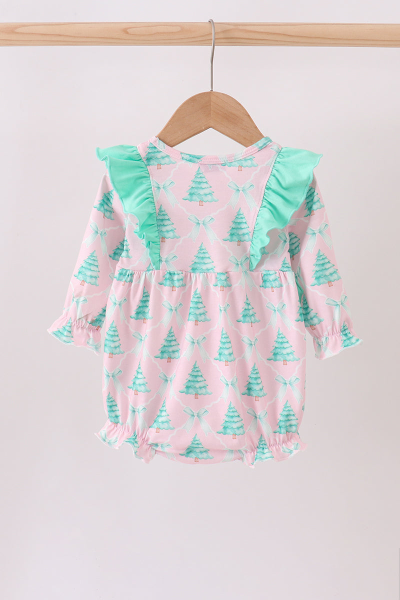 Baby romper with Christmas tree pattern on a wooden hanger against a light background