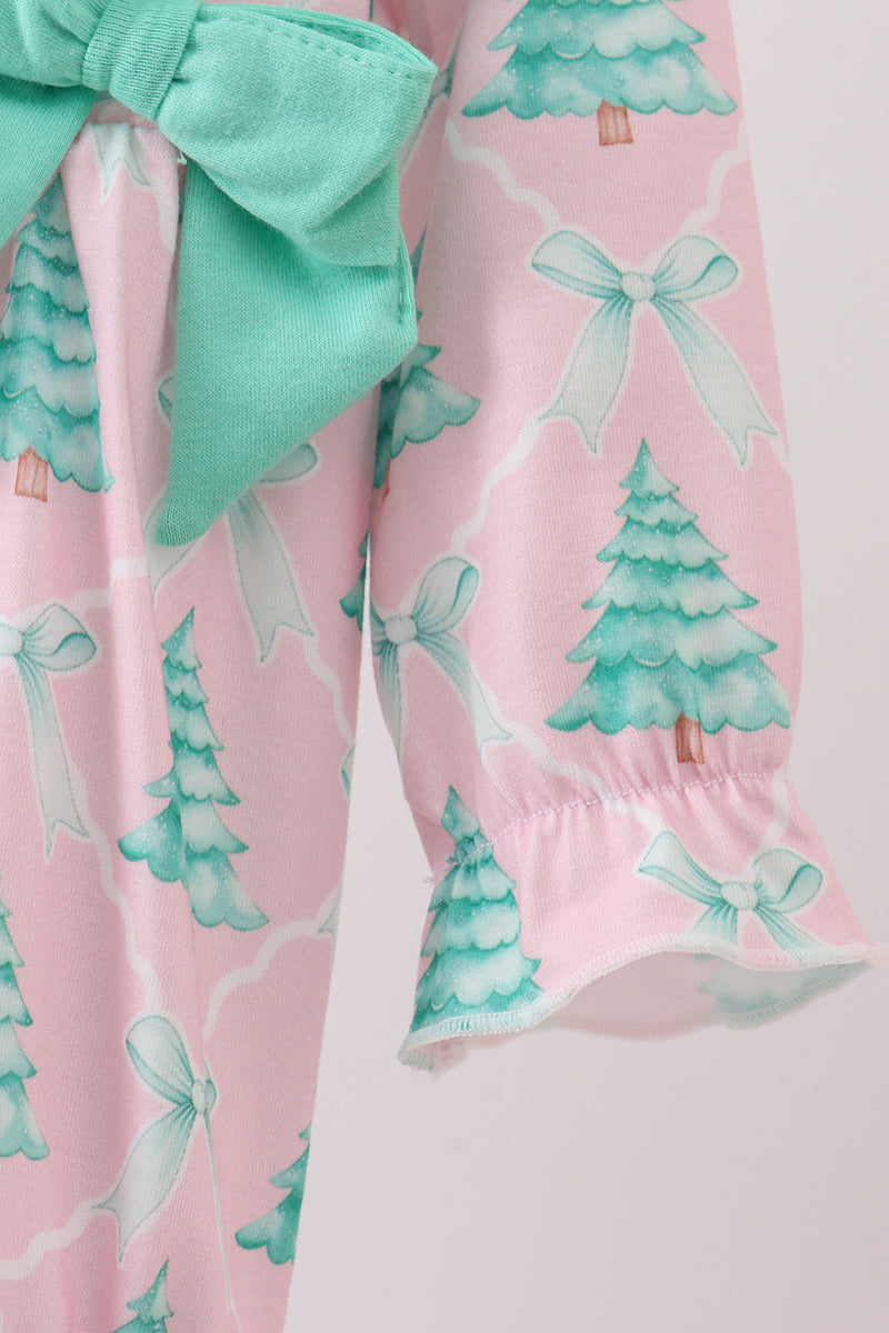 Pink pants with green tree and bow pattern on a white background
