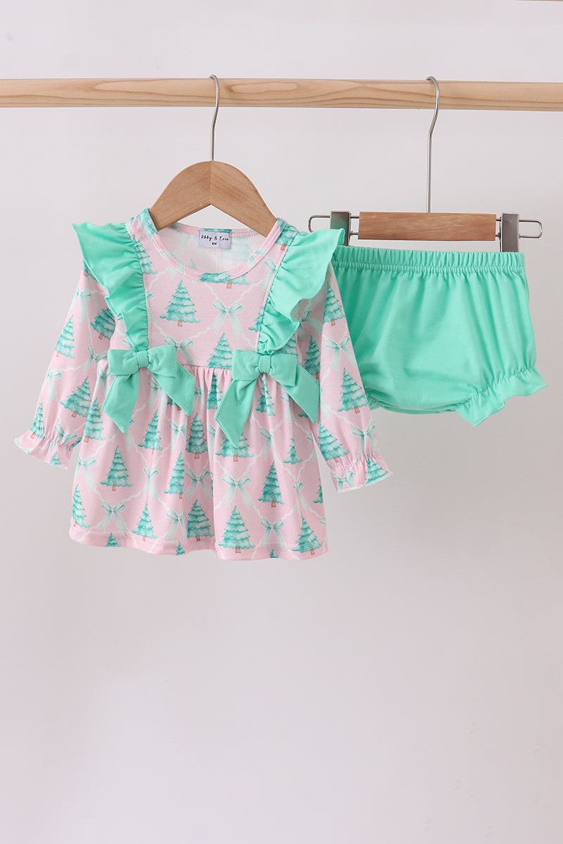 Children's outfit with pink and green top and matching shorts on a hanger against a white background.