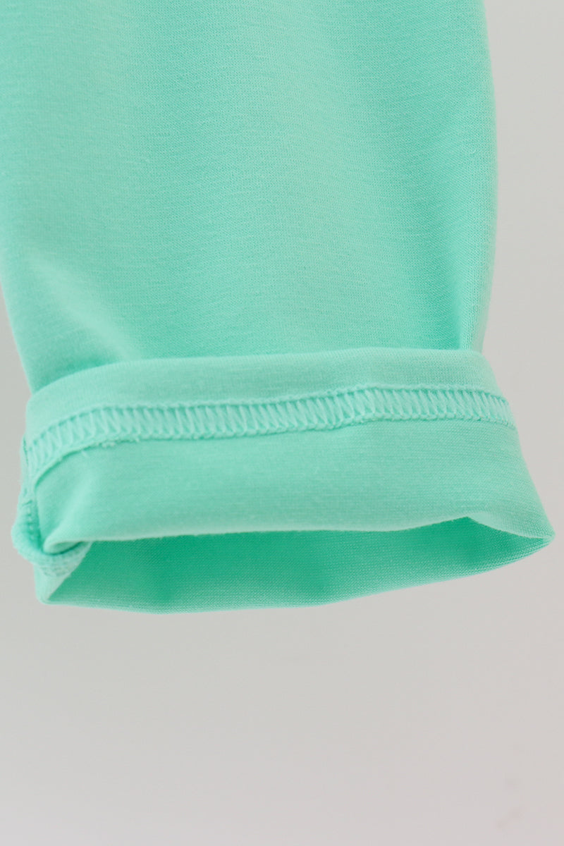 Close-up of a mint green fabric with a plain background
