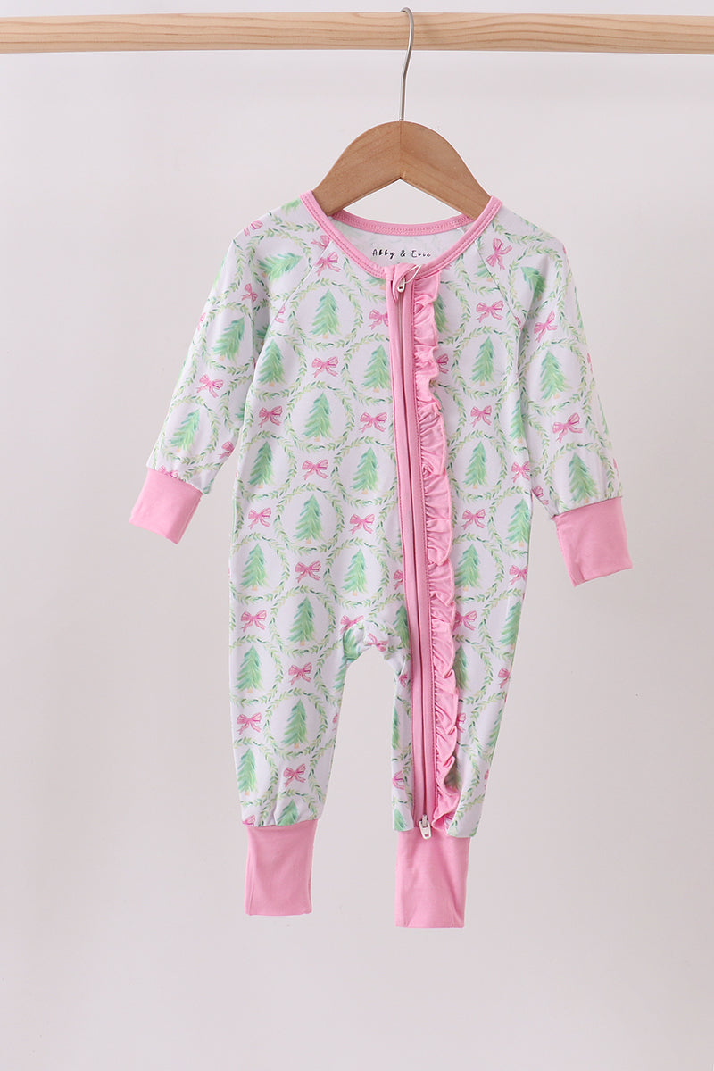 Children's onesie with pink and green pattern on a hanger against a white background