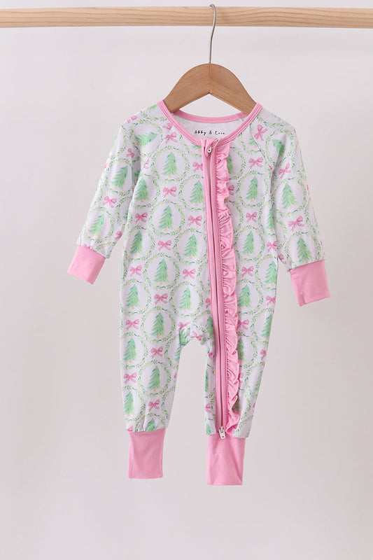 Children's onesie with pink and green pattern on a hanger against a white background
